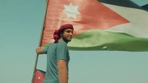Man Standing with a Jordanian Flag Stock Footage 271563469