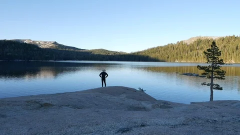 Man standing at a lake Stock Footage 112587359