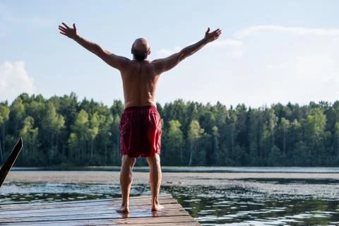 Man standing on a lake Stock Photos