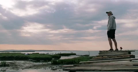Man standing on lake pier. Stock Footage 160157647