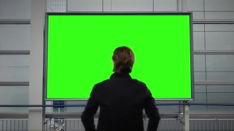 Man Standing Before Large Green Screen Digital Billboard Mockup Stock Footage 342136681