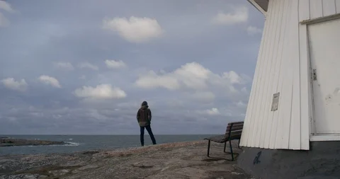 Man standing by a lighthouse. Stock Footage 106120955