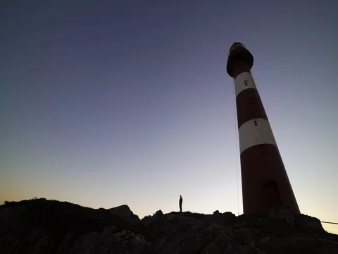 Man standing. lighthouse. silhouette 4k Stock Footage 77973876