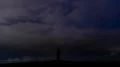 The man standing on the lightning stream background. time lapse 4k or 4k+ Resolution