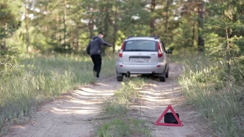 A man is standing in the middle of the forest, his car has broken down Video stock 158044712