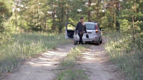 A man is standing in the middle of the forest, his car has broken down Video stock 158044984