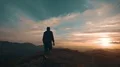 The man standing on the mountain against the beautiful sunset 4k or 4k+ Resolution