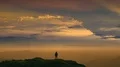 The man standing on a mountain on a beautiful cloud stream background 4k or 4k+ Resolution
