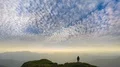 The man standing on a mountain with a beautiful cloud stream background 4k or 4k+ Resolution