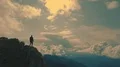 The man standing on a mountain cliff with a picturesque landscape 4k or 4k+ Resolution