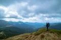 The man standing on the mountain on the cloud background Photo