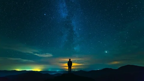 The man standing on the mountain with a cloud stream background. time lapse Stock Footage 96300383