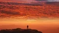 The man standing on a mountain on a cloud stream background. time lapse 4k or 4k+ Resolution