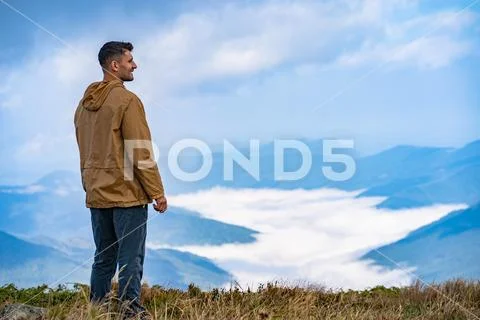 The man standing on the mountain landscape background Stock Photos