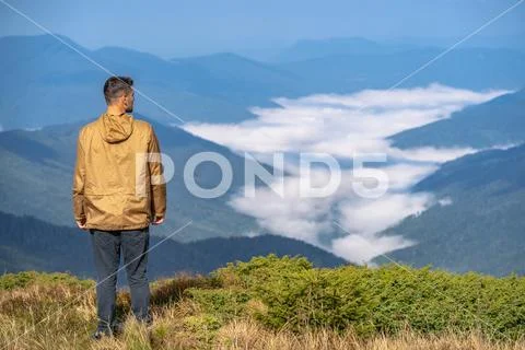 The man standing on the mountain landscape background Stock Photos
