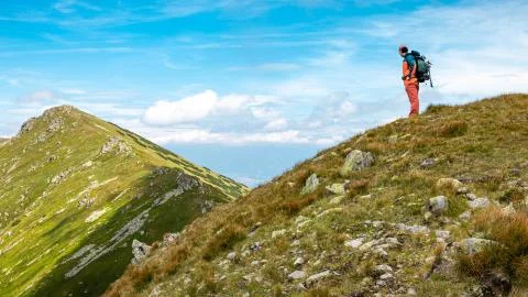 Man standing on a mountain looking at a nice view Stock Photos