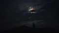 The man standing on the mountain on the moonlight background 4k or 4k+ Resolution