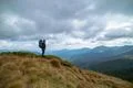 The man standing on the mountain on the rainy cloud background Photo
