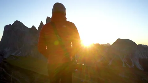 Man standing on mountain ridge during sunrise Stock Footage 143380777