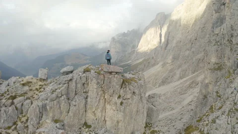 Man standing on mountain ridge epic drone view dolomites Stock Footage 143374443