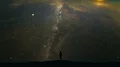 The man standing on a mountain on the starry sky background. time lapse 4k or 4k+ Resolution