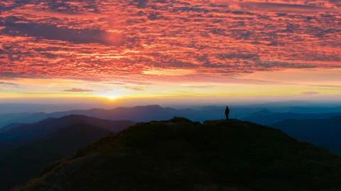 The man standing on the mountain on the sunset background Stock Footage 107278930