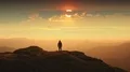 The man standing on a mountain top against the beautiful sunset. time lapse 4k or 4k+ Resolution