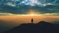 The man standing on the mountain top against the picturesque sunset 4k or 4k+ Resolution