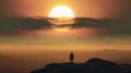 The man standing on a mountain top on the bright sunrise background. time lapse 4k or 4k+ Resolution