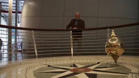 Man standing by moving pendulum Stock Footage 36150767