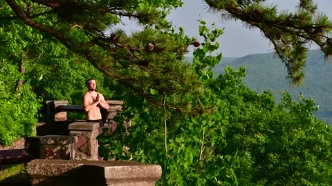 Man standing in natural background and soking in the sun Stock Footage 254796635
