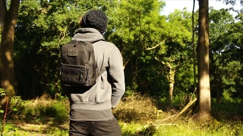 Man standing in Nature Forest with Backpack Stock Footage 111856699