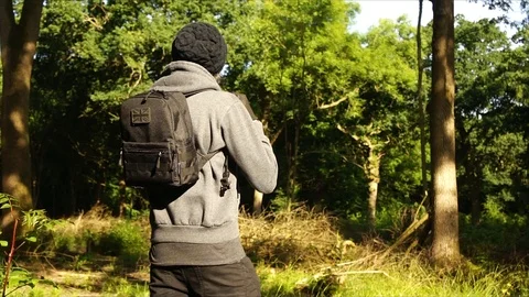 Man standing in Nature Forest with Backpack Stock Footage 111856731