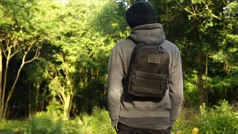 Man standing in Nature Forest with Backpack Stock Footage 111856801