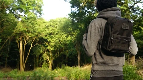 Man standing in Nature Forest with Backpack Stock Footage 111856805
