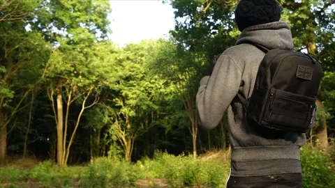 Man standing in Nature Forest with Backpack Stock Footage 111856838