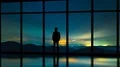 The man standing near panoramic window on a starry sky background. time lapse 4k or 4k+ Resolution