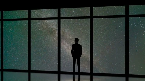 The man standing near panoramic windows on the starry sky background. time lapse Video stock 94170083