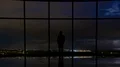 The man standing near the window on a city lightning background. time lapse 4k or 4k+ Resolution