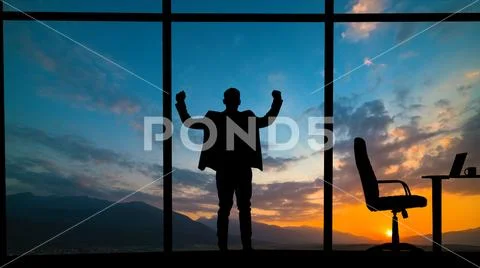 The man standing near the window on a mountain sunset background Stock Photos