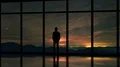 The man standing near window on a sky with stars background. time lapse 4k or 4k+ Resolution