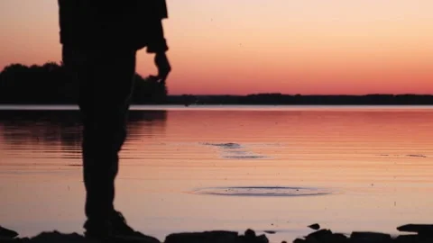 Man standing next to lake at sunset V1-0013 Stock Footage 233209792
