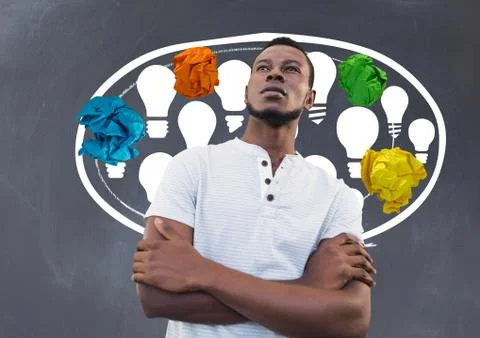 Man standing next to light bulbs chat bubble with crumpled paper balls in front Stock Photos
