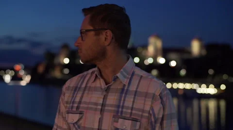 Man standing next to the river and doing serious look to the camera, steadycam s Stock Footage 57411352