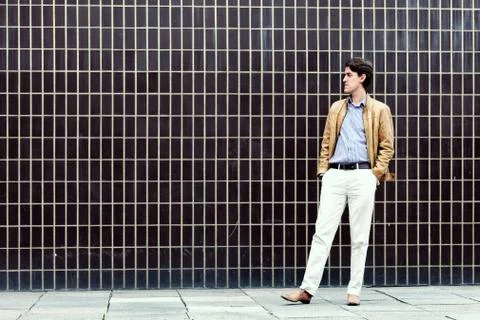 Man standing next to a wall Stock Photos