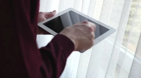 Man standing next to the window and using tablet pc. Close up. Stock Footage 61281669