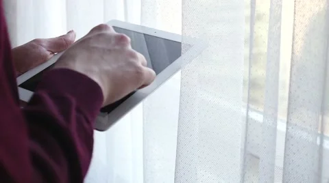 Man standing next to the window and using tablet pc. Close up. Stock Footage 61281720