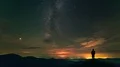 The man standing on a night mountain on the cloud stream background. time lapse 4k or 4k+ Resolution