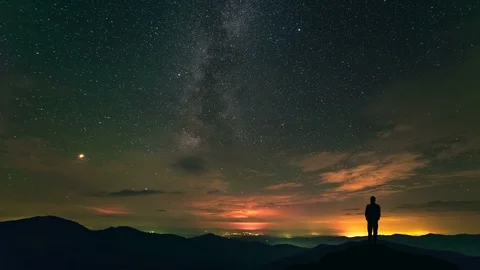 The man standing on a night mountain on the cloud stream background. time lapse Stock-Footage 96289988