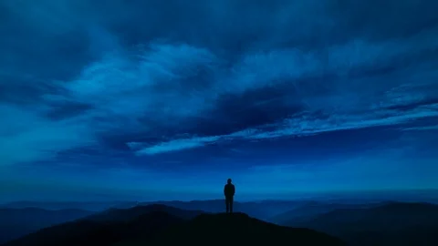 The man standing on a night mountain with a cloud stream. time lapse Video stock 96290829